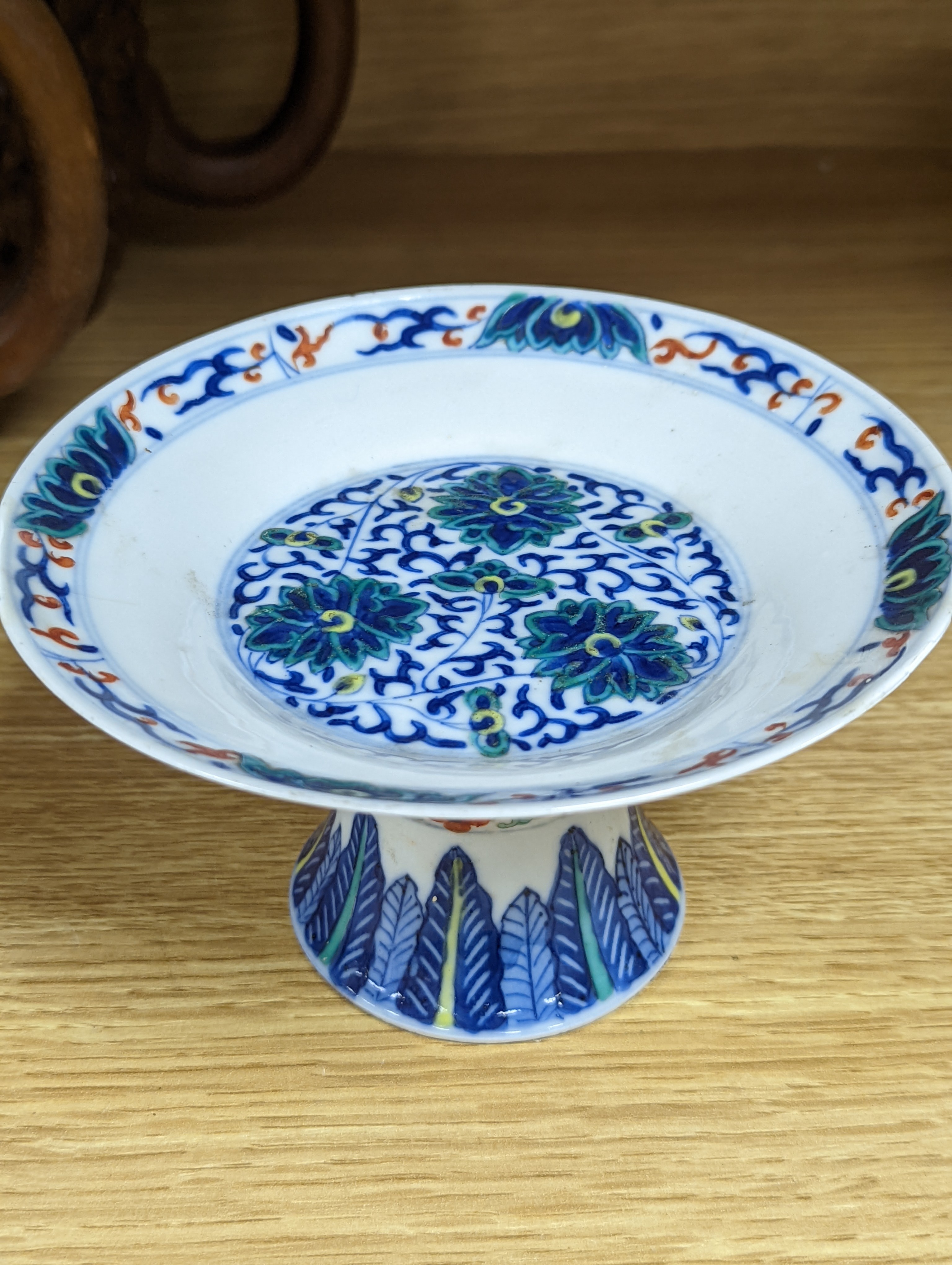 A Chinese blue and white water pipe vessel, a doucai stem dish and a Japanese Imari bowl, 19th century, (3)